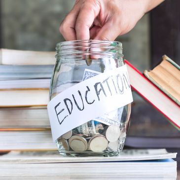 A jar of coins labeled Education resting on books